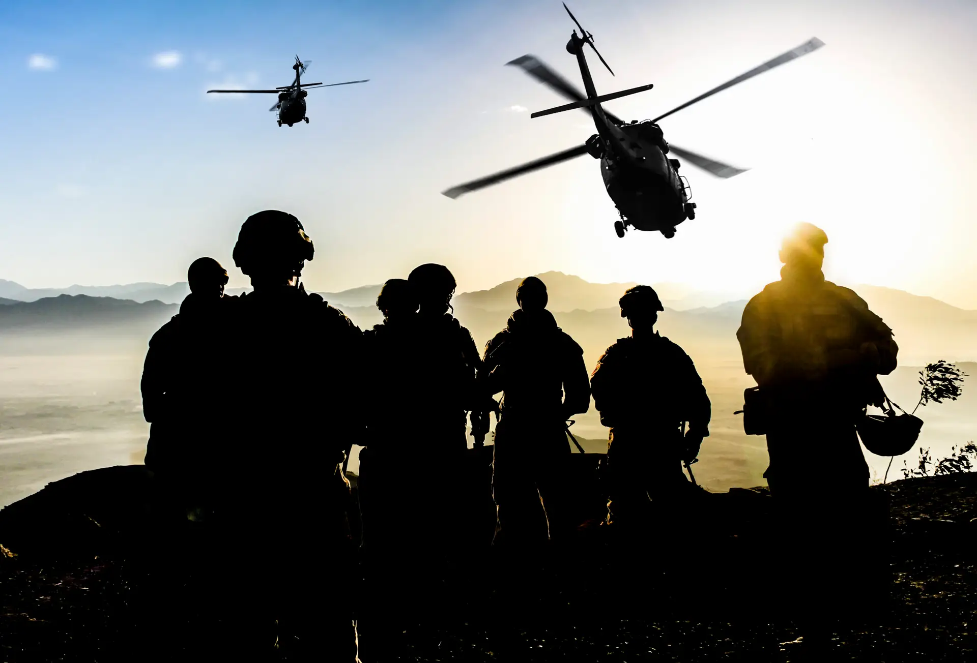 silhouettes of soldiers during military mission at dusk